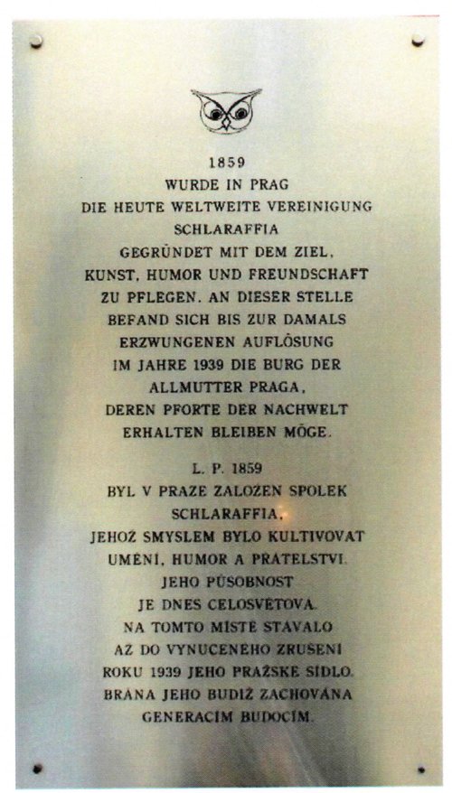 Fotografierte Metalltafel mit eingraviertem Uhukopf und deutschem sowie tschechischem Text zur Gründung der Schlaraffia 1859 und der Auflösung 1939